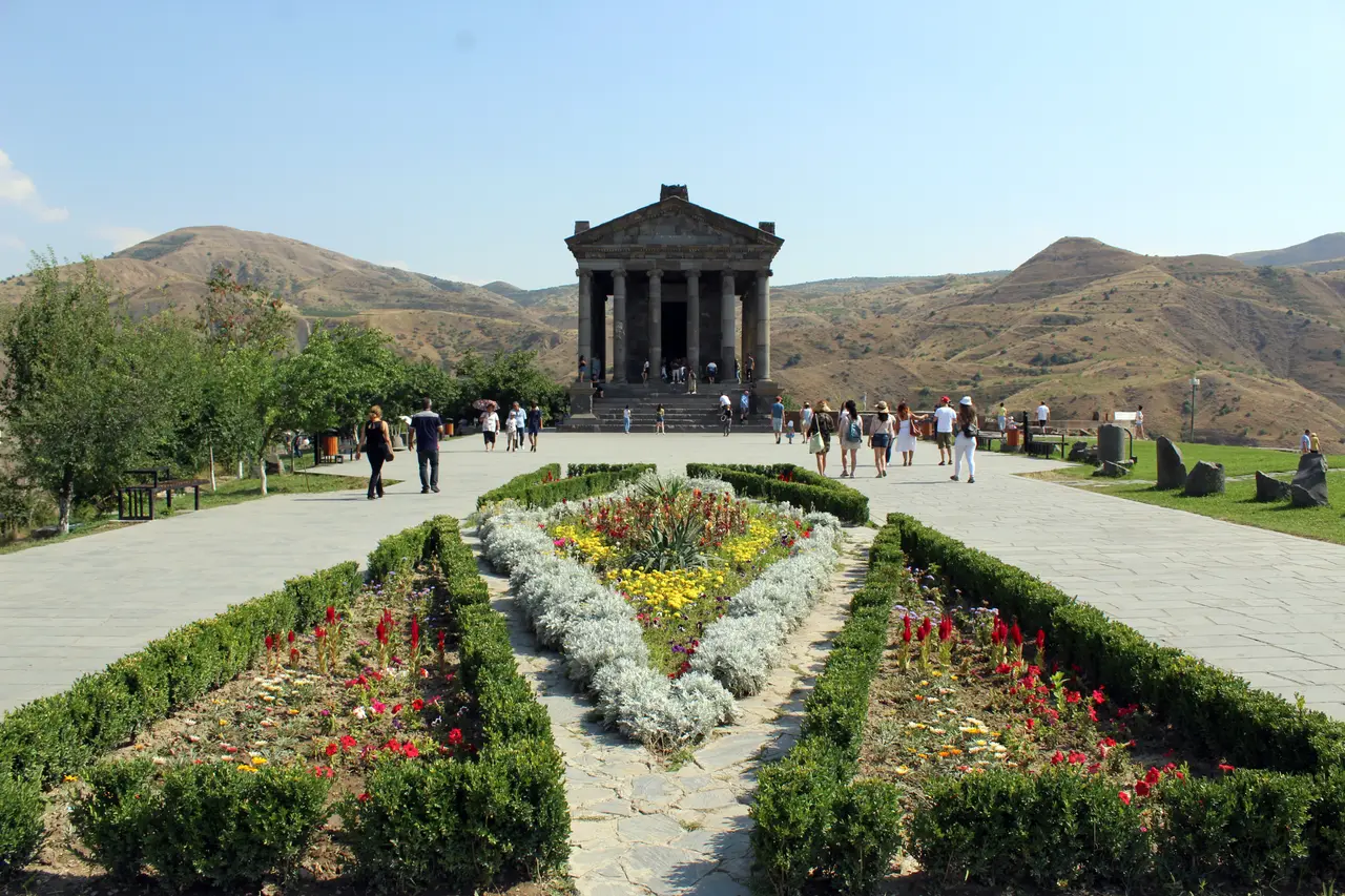 The colonnaded first-century Greco-Roman temple of Garni standing on its clifftop under a blue sky