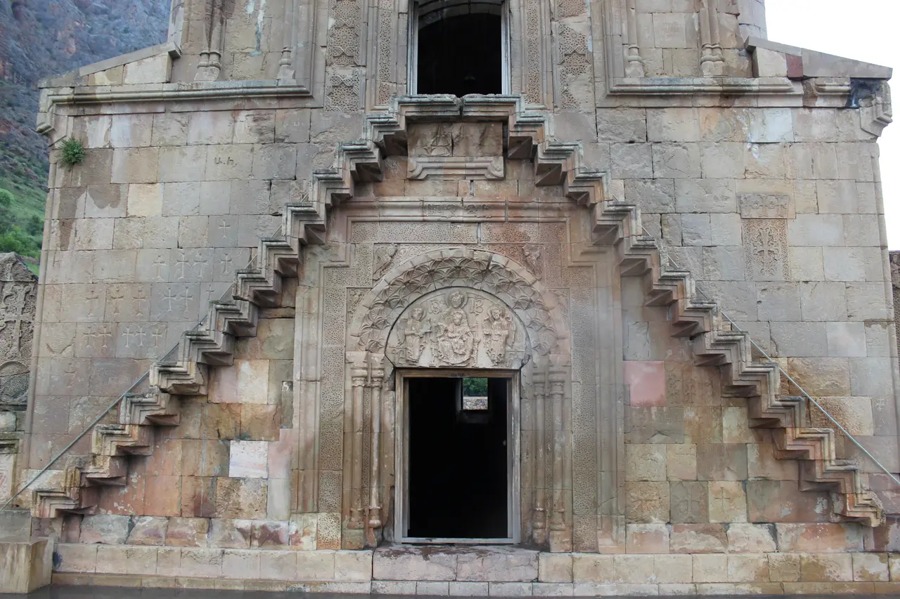 The two-storey Burtelashen church at Noravank against the brick-red cliffs of the Amaghu gorge