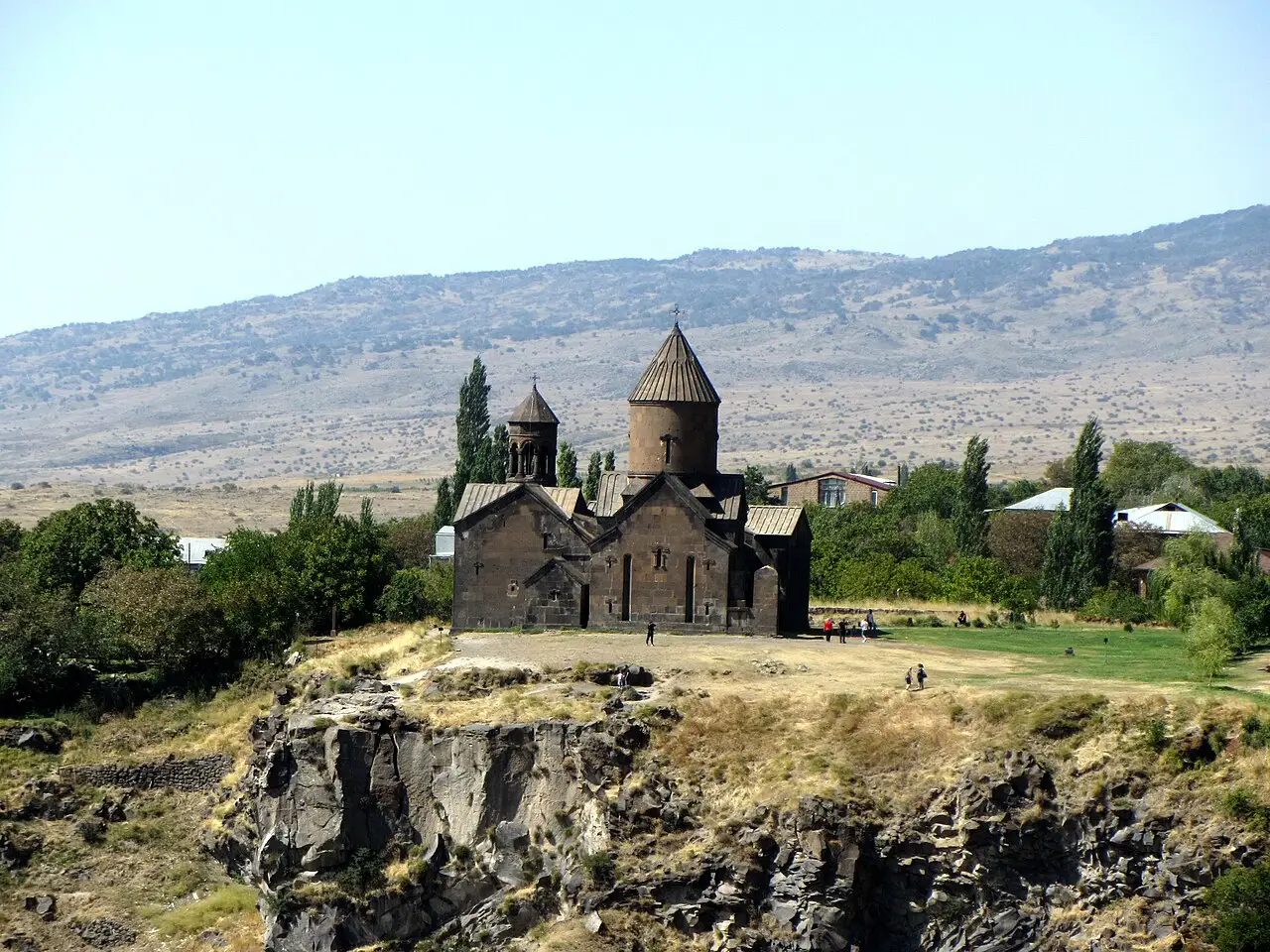 The grey stone church and gavit of Saghmosavank monastery on the edge of the Kasagh gorge