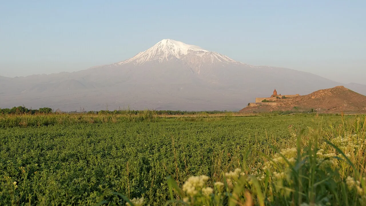 Mount Ararat rising above Khor Virap monastery across the fields of the Ararat plain