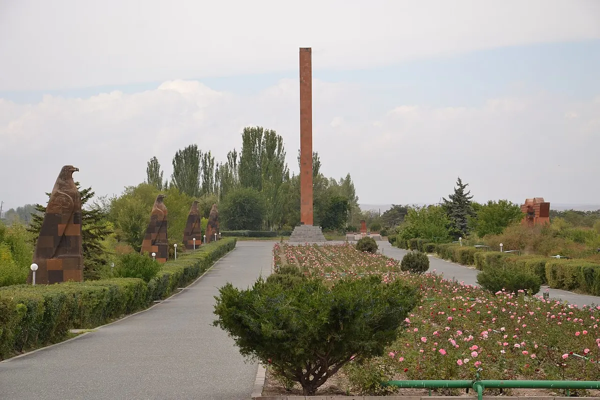 Red-tufa winged eagles lining the approach avenue at the Sardarapat Memorial complex