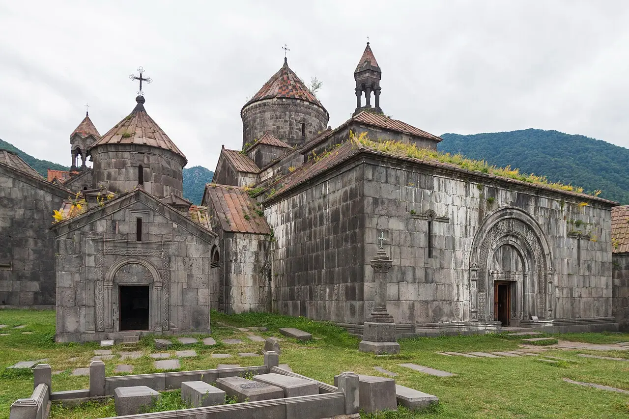 The stone churches and gavit of Haghpat monastery on a green plateau in Lori province