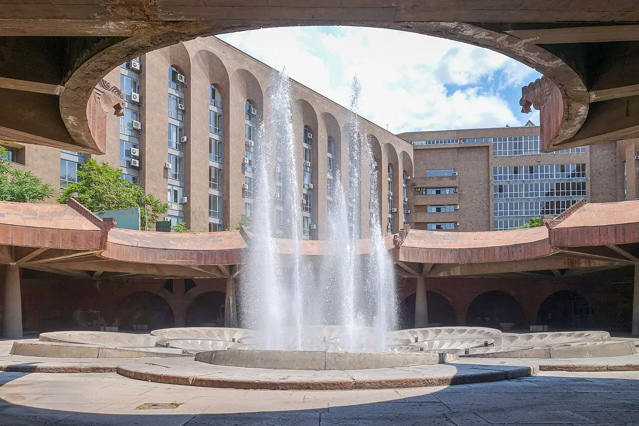 The fountains on Republic Square in central Yerevan at dusk with the pink-tuff government buildings behind