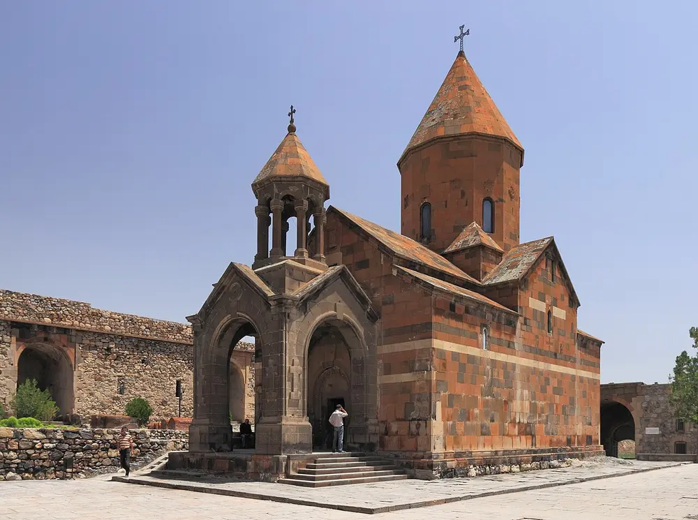 Khor Virap monastery on its hill with the snow-capped cone of Mount Ararat rising behind