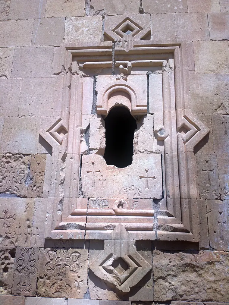 The two-storey Burtelashen church at Noravank against the red cliffs of the Amaghu gorge