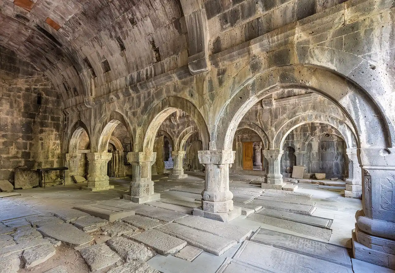The arcaded stone hall of Sanahin monastery with rows of heavy pillars and vaults