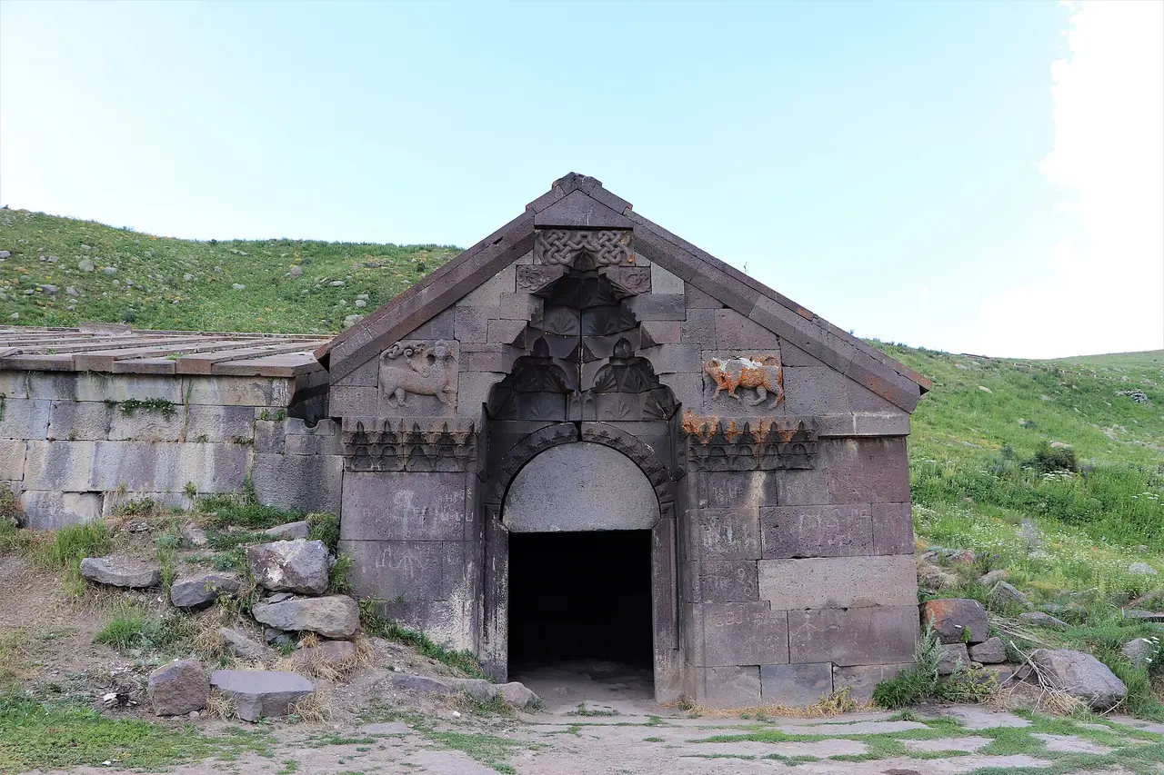 The carved stone portal of Orbelian caravanserai on the Selim pass in green highland