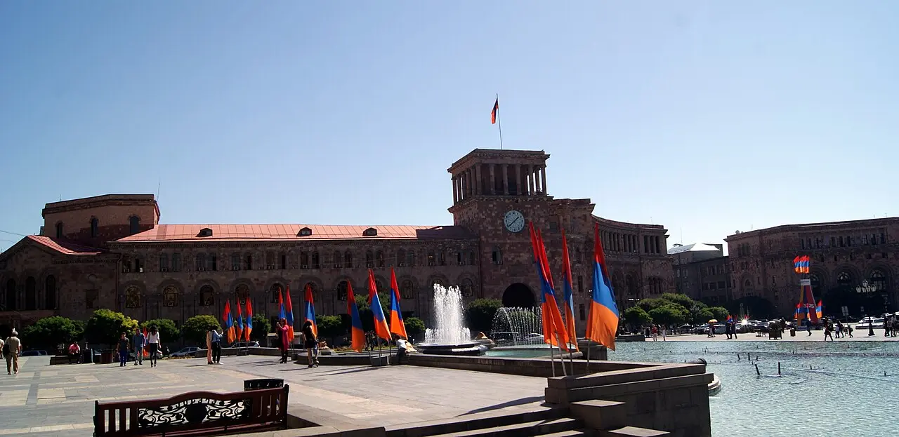 A long row of Armenian flags and tricolour decorations strung along a Yerevan street