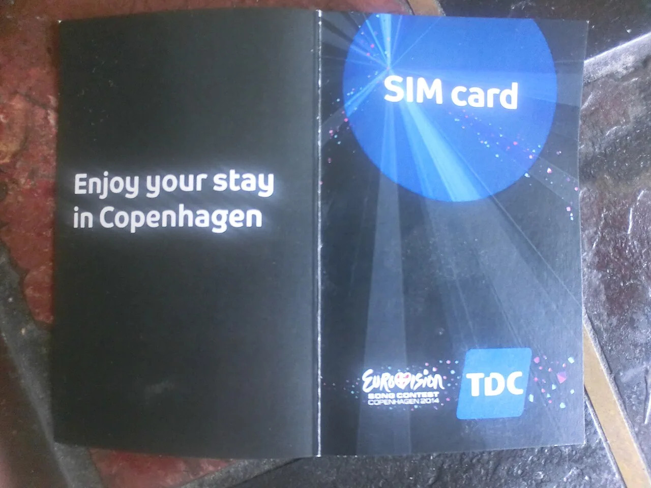 A prepaid mobile SIM card held in a hand