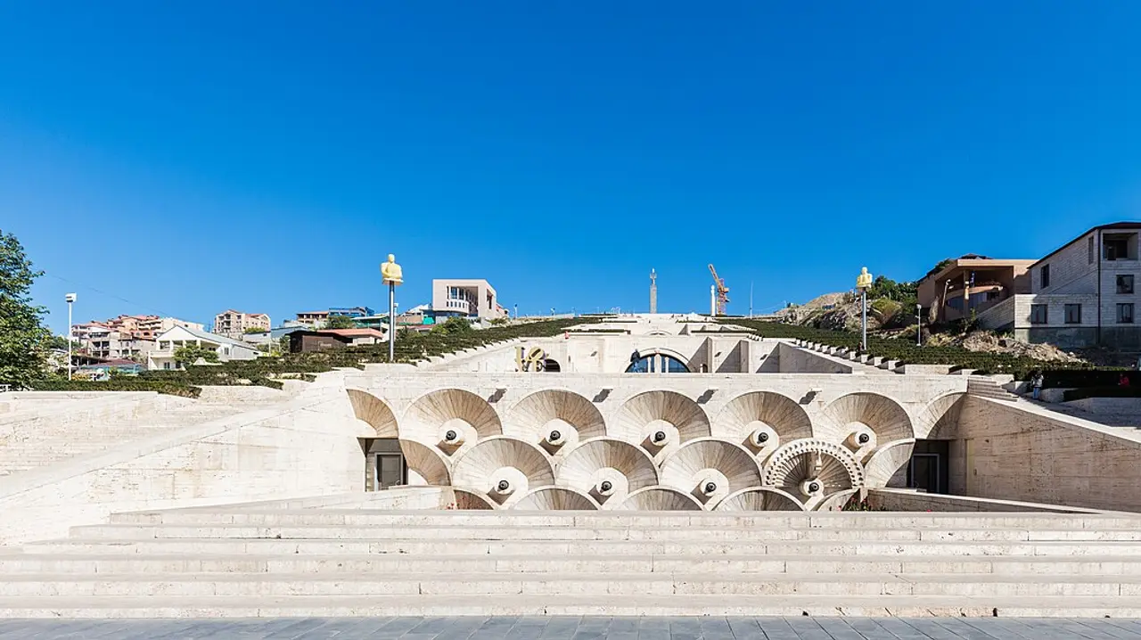 The stone terraces and fountain arches of the Cascade complex in Yerevan under a deep blue sky