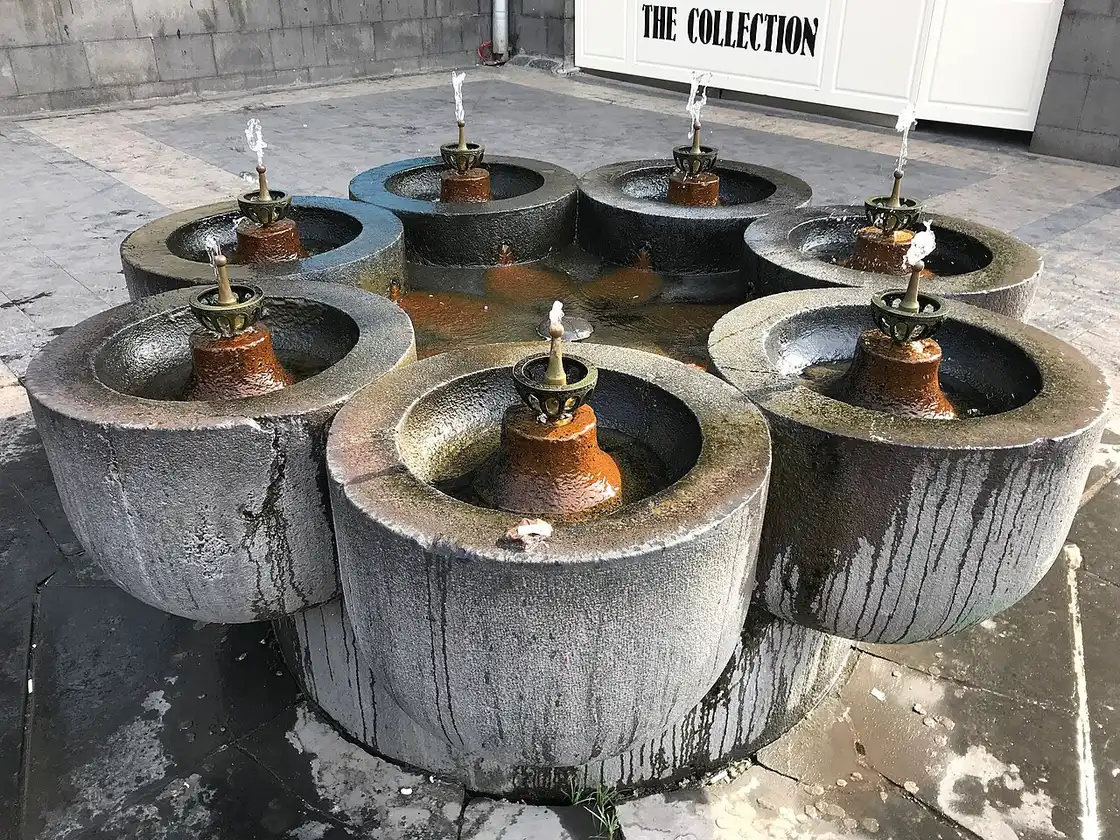 The seven linked stone basins of the Yotnaghbyur drinking fountain in Yerevan, each with a jet of water