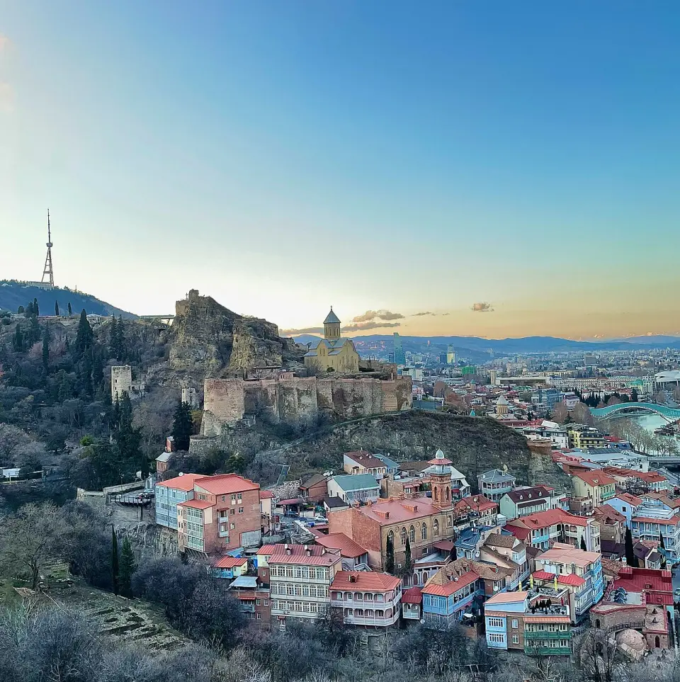 Narikala fortress and old Tbilisi rooftops at dusk