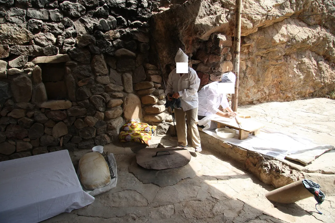 A roadside lavash stall on the way to Noravank, with a woman baking flatbread over a fire