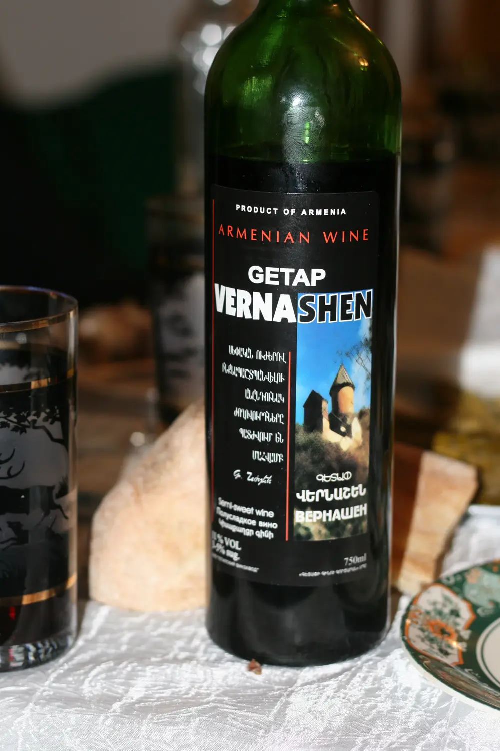 A glass and bottle of Armenian red wine