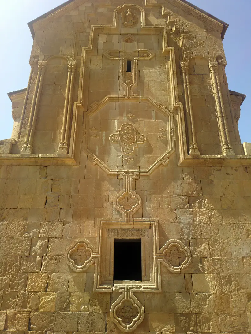 The two-storey Burtelashen church at Noravank glowing against the brick-red cliffs of the Amaghu gorge