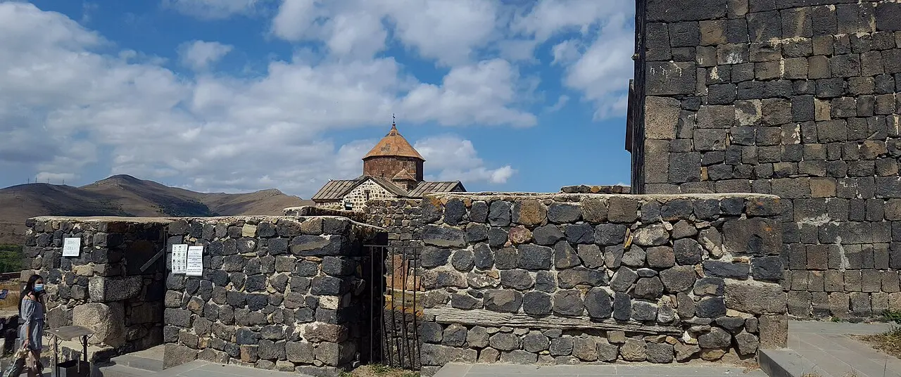 The dark stone churches of Sevanavank on their peninsula above the wide blue expanse of Lake Sevan