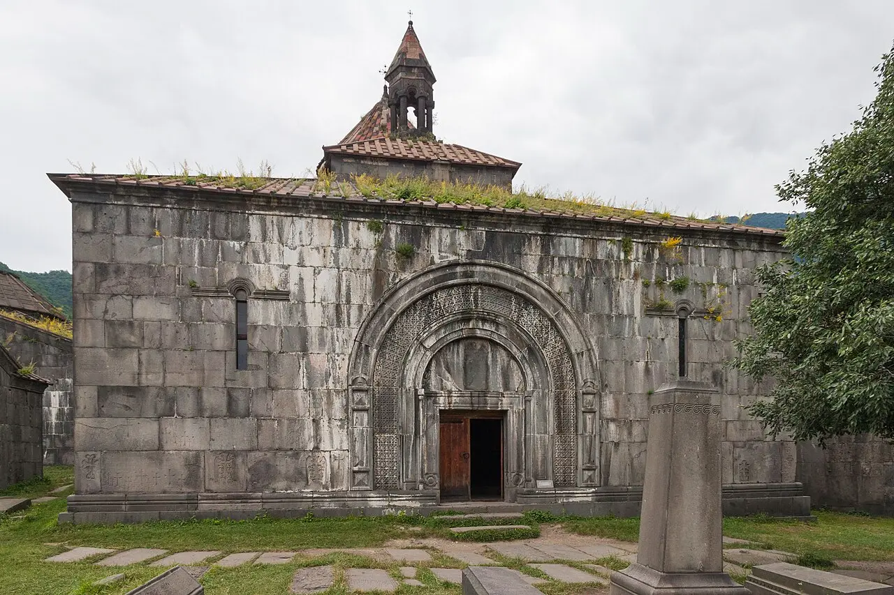 The carved main portal and mossy stone facade of Haghpat monastery in Lori, northern Armenia