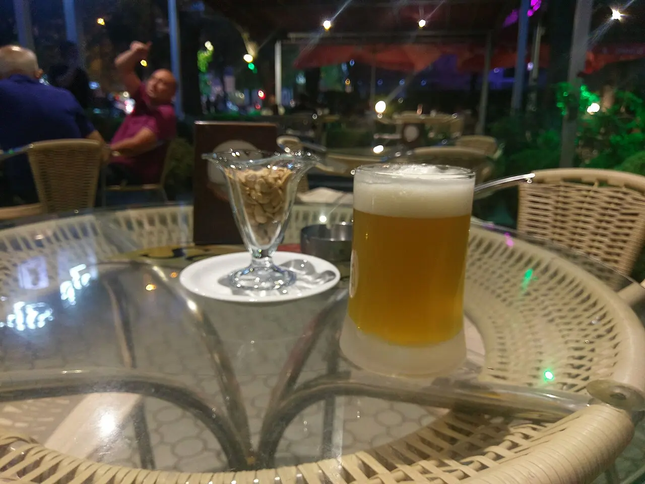 An open-air beer garden with wooden tables and umbrellas in central Yerevan
