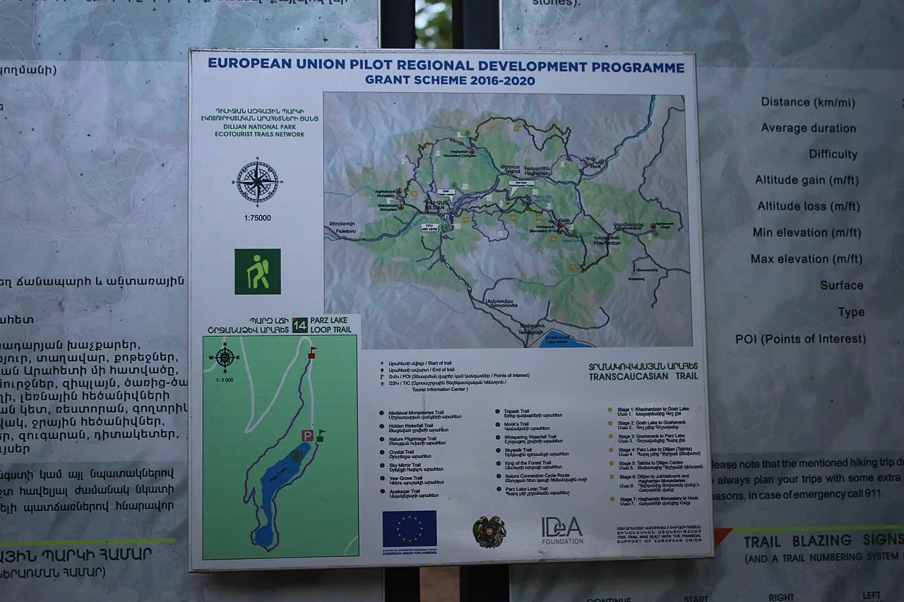 Still green water of Parz Lake ringed by dense forest in Dilijan National Park