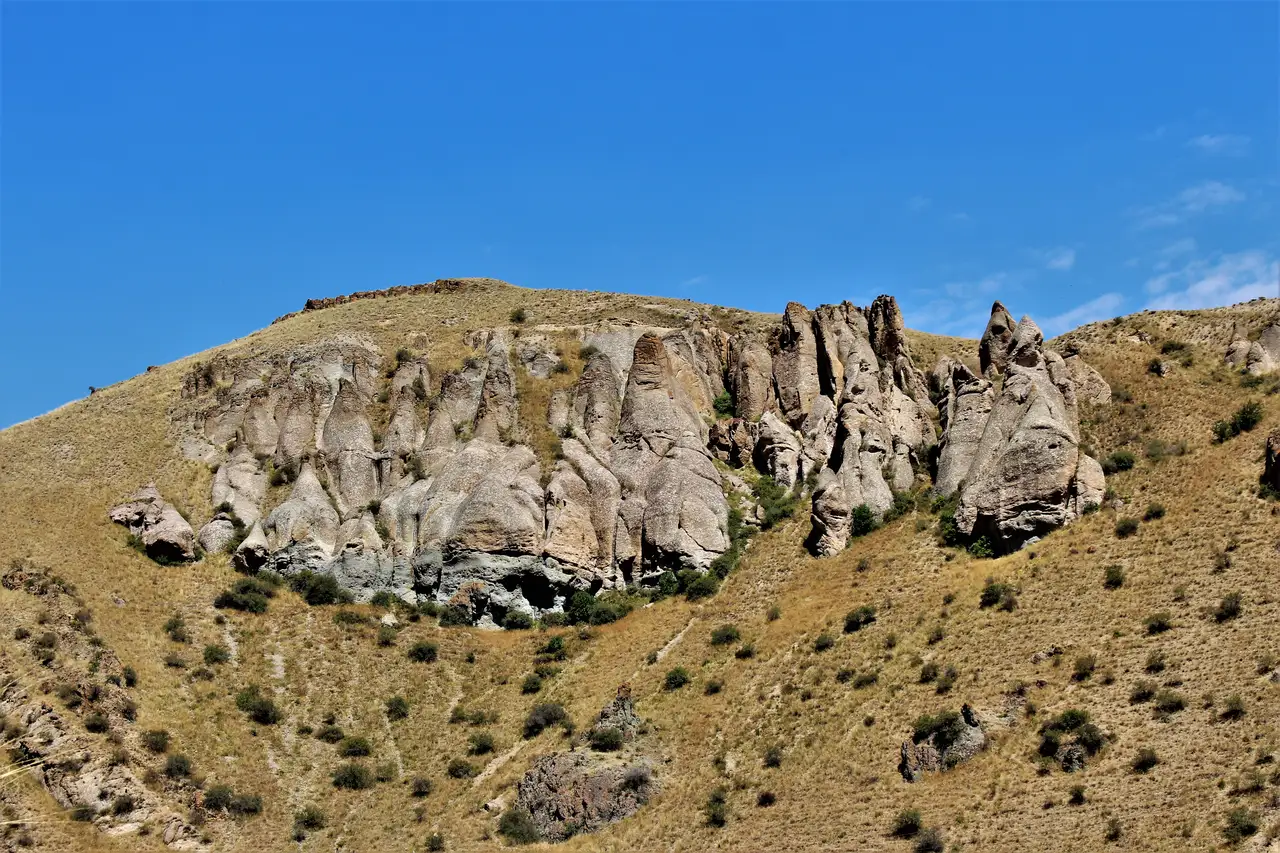 The deep green Vorotan River gorge in southern Armenia with a thin road visible along the far slope