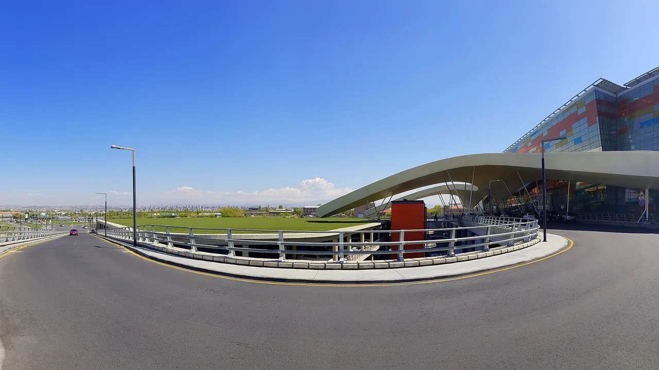 The long modern terminal of Zvartnots International Airport west of Yerevan, with the road in and the Ararat plain beyond