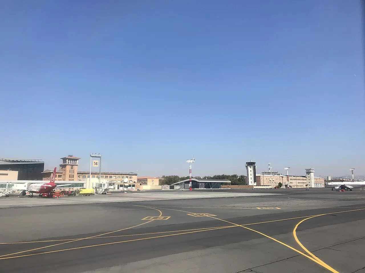 Airside apron at Zvartnots: stand markings 14 and 15, aircraft and the control tower