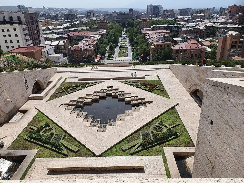 The white stone terraces and stair flights of the Yerevan Cascade rising in stacked levels against a blue sky