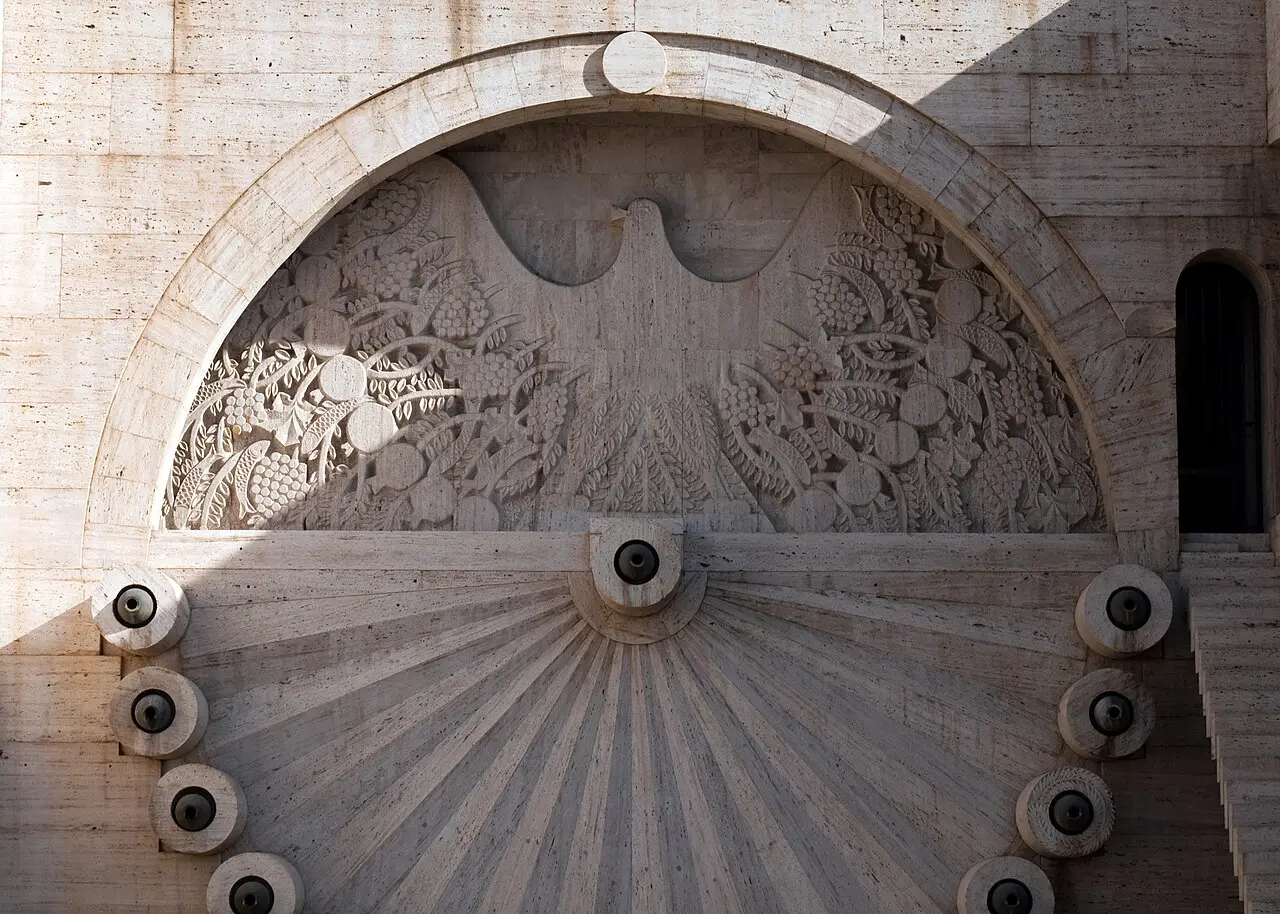 Looking up the Cascade terraces with fountains, carved stone walls and a sculpture on a landing