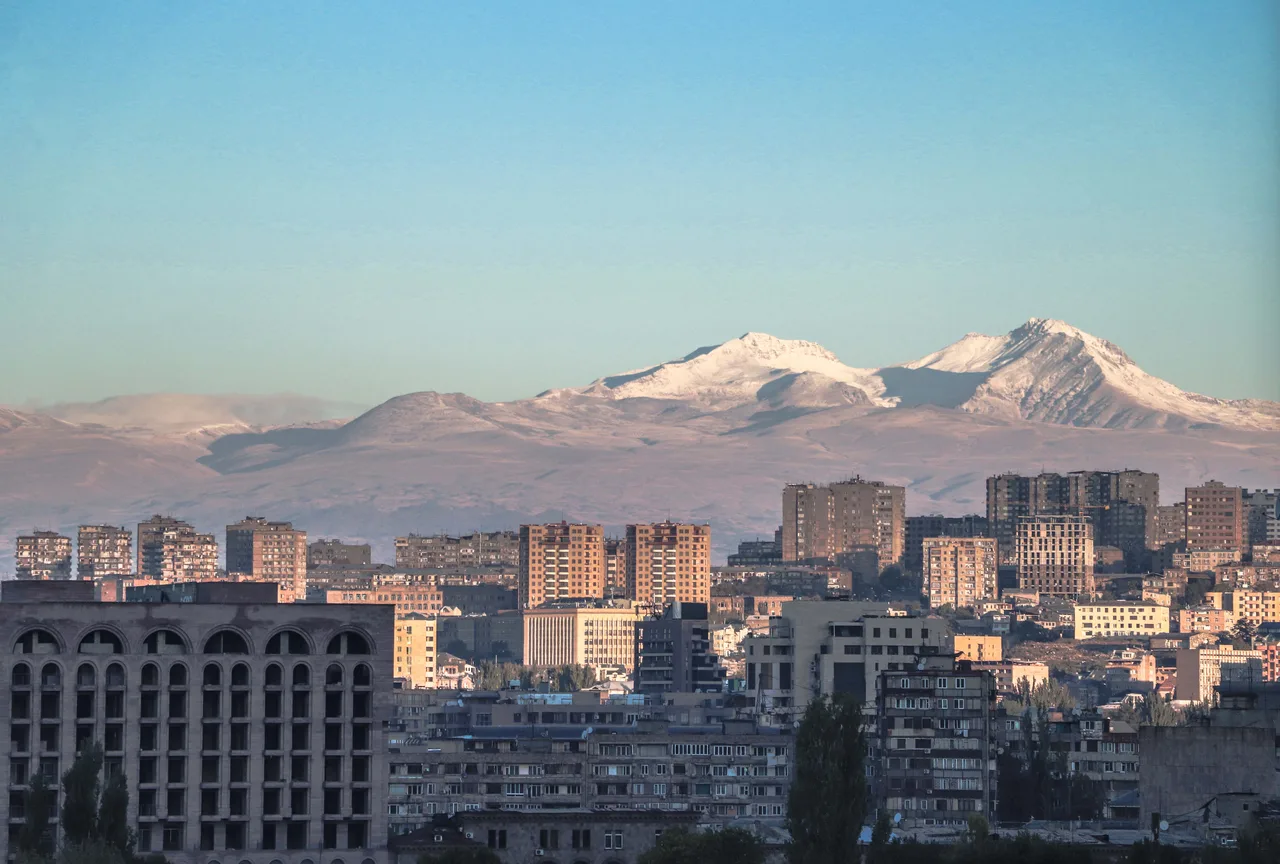 Yerevan spreading out below Mount Aragats under a clear sky