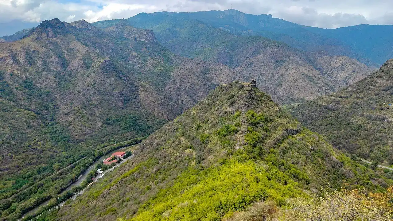 The forested Debed canyon near Haghpat with a road threading the valley floor and ridges stacked to the horizon