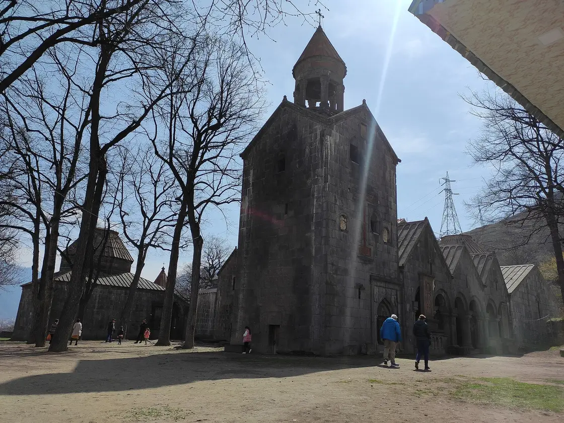 The belfry and clustered stone churches of Sanahin monastery among bare trees on the plateau above Alaverdi