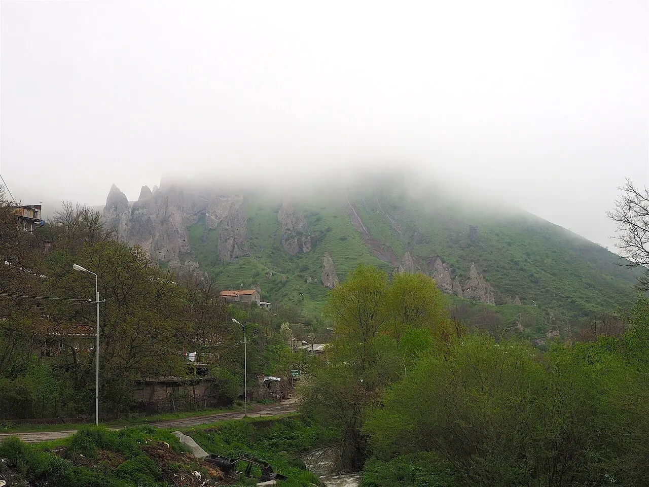 Stone houses and trees in the centre of Goris under a clear sky in Syunik