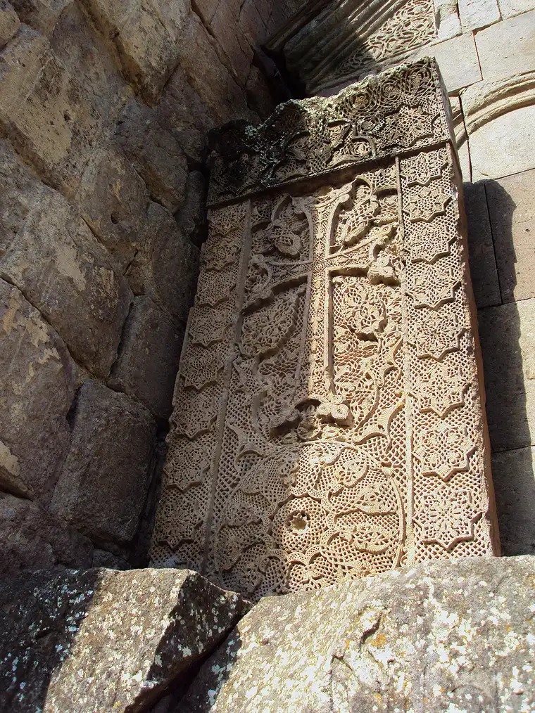 The intricately carved openwork khachkar cut by the master Poghos in 1291 at Goshavank, its cross set on a lace-like stone rosette