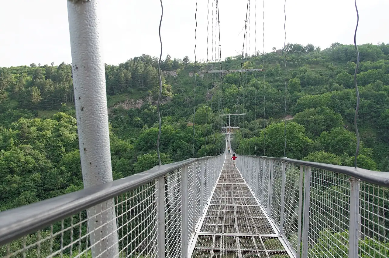 The long swinging suspension bridge of Old Khndzoresk strung across the green Khor Dzor gorge