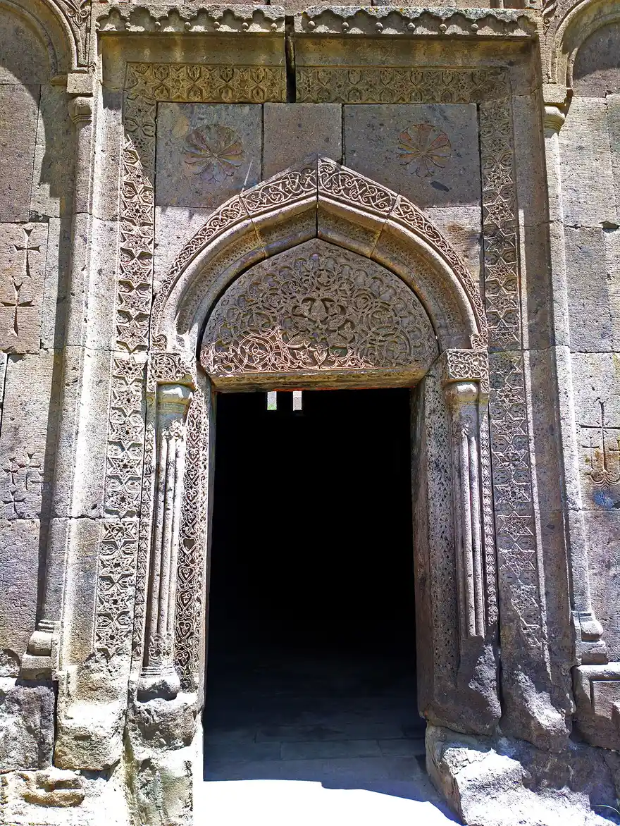 Deeply carved stone portal of the Grigor Lusavorich church at Goshavank, its pointed tympanum filled with interlaced floral ornament