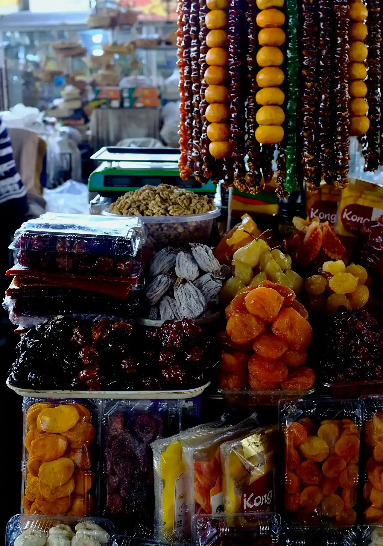 Mounds of dried apricots, peaches and nuts piled on a stall inside GUM Market in Yerevan