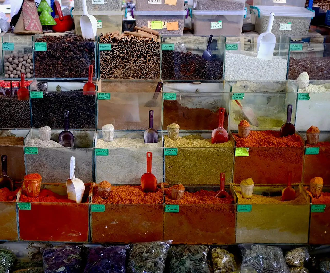 Open sacks of ground spices and dried herbs at a counter in GUM Market, Yerevan