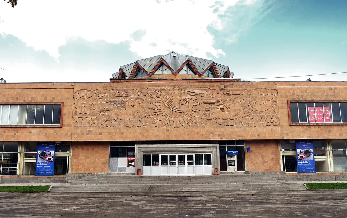 Exterior of Gyumri railway station with its arched facade and plaza in front