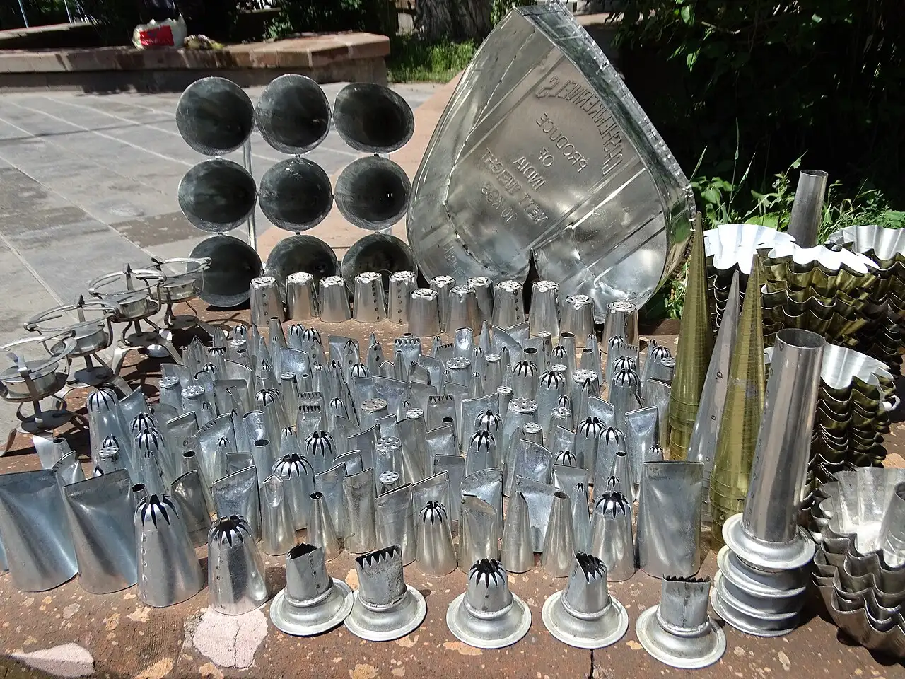 A display of handmade tin utensils in a craft workshop in Gyumri