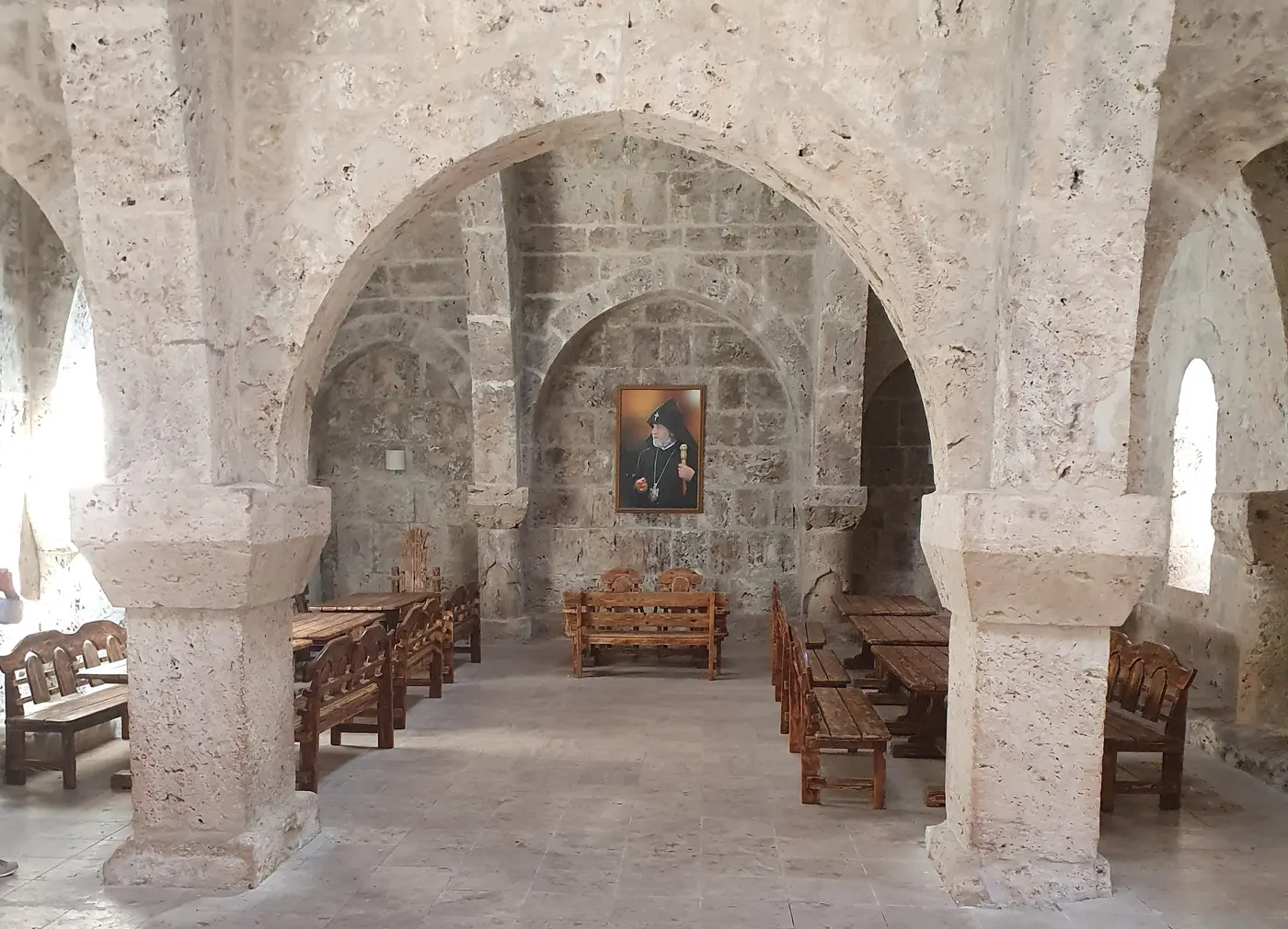 The vaulted stone refectory of Haghartsin, its two halls roofed with intersecting arches on thick round pillars