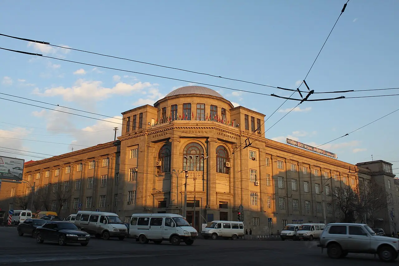 The domed main building of Yerevan State Medical University lit by evening sun