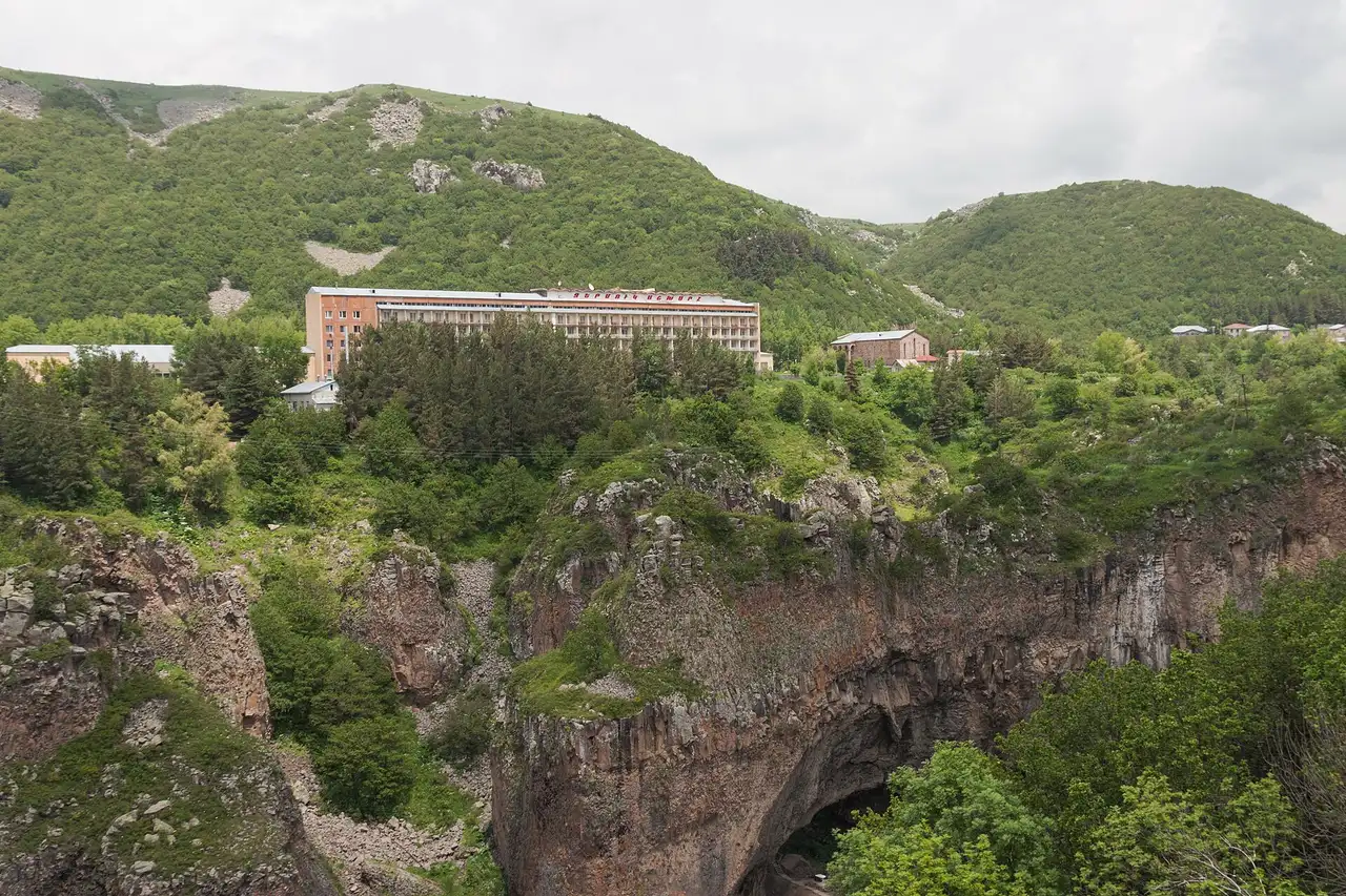 A long Soviet-era sanatorium building on the green Jermuk plateau above the Arpa gorge