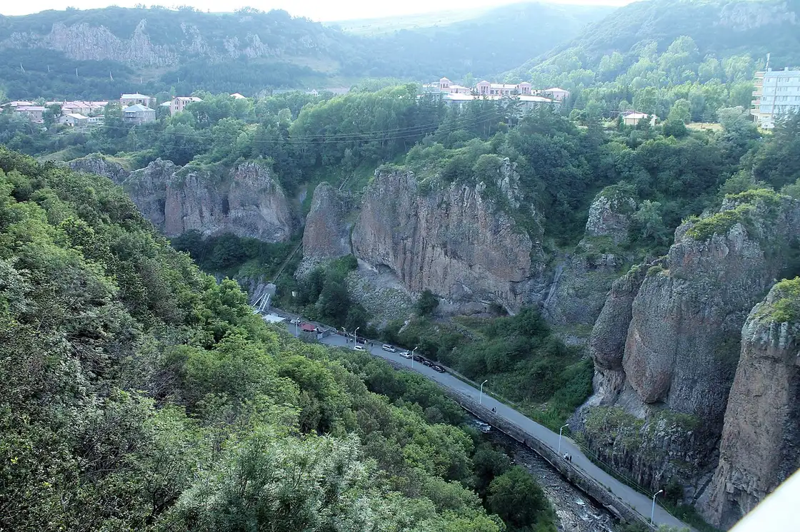 The spa town of Jermuk spread across a high green plateau with Soviet-era sanatorium buildings and mountains behind