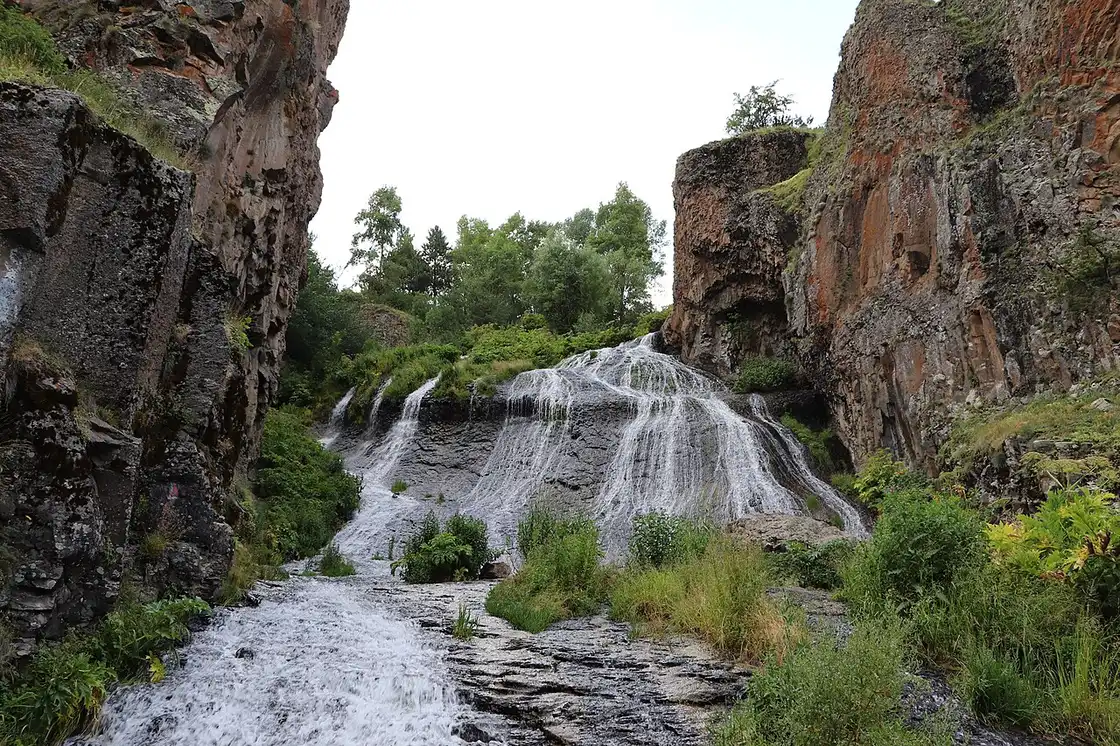 A close view of the Jermuk waterfall streaming down the rock face in fine strands, the source of its "Mermaid Hair" nickname