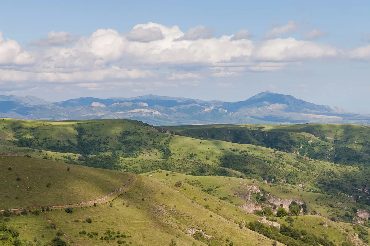 The wide Khor Dzor gorge at Khndzoresk with cave openings dotting both rocky slopes