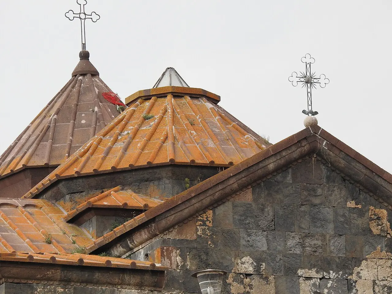 The compact stone church of Hayravank monastery on a green headland at the edge of Lake Sevan