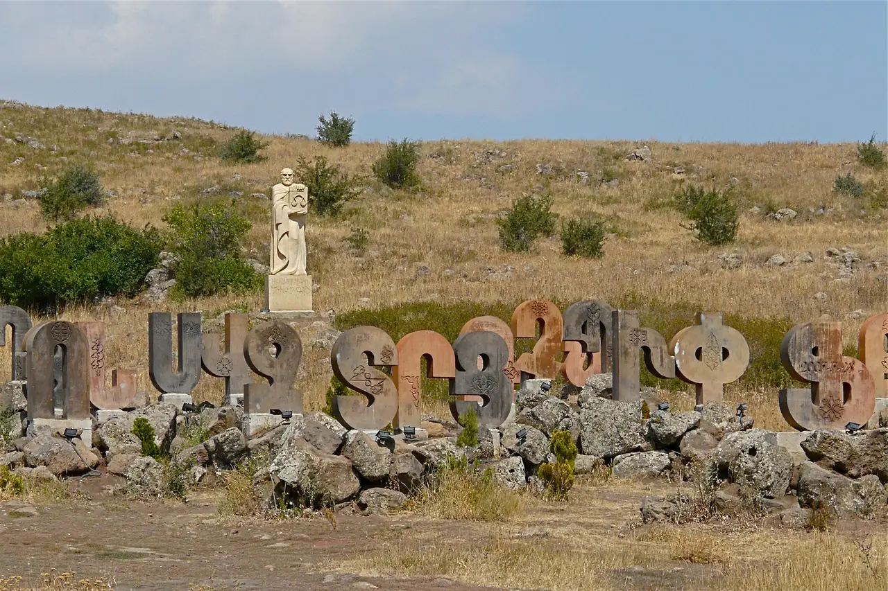 Giant carved stone letters of the Armenian alphabet standing in a field at the Alphabet Park near Artashavan
