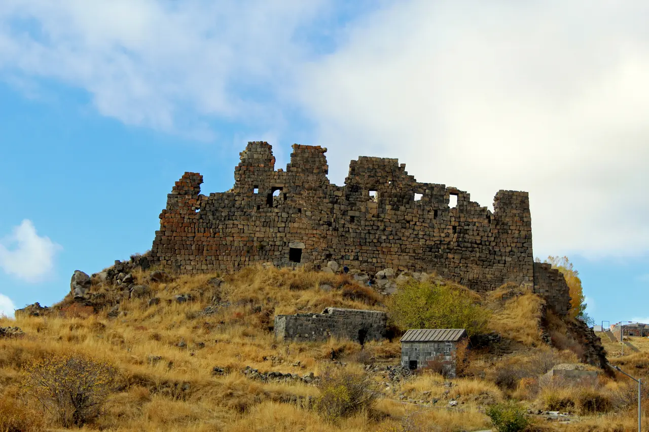 The stone walls of Amberd fortress and the Vahramashen church on a spur of Mount Aragats