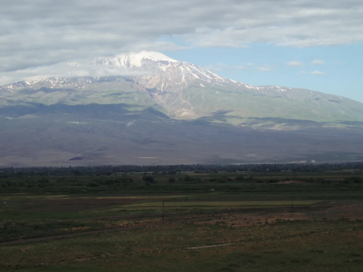 The fenced no-mans-land of the closed Armenia-Turkey border below Khor Virap, with Mount Ararat rising on the Turkish side
