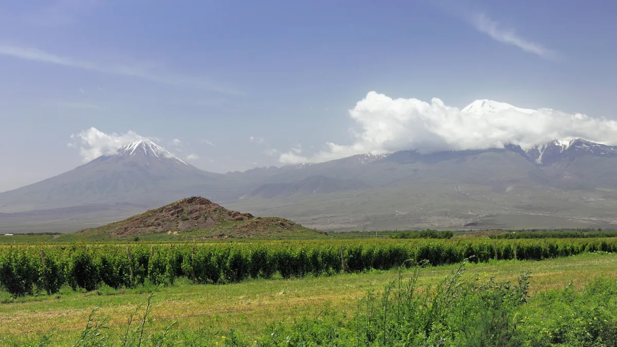 The two peaks of Mount Ararat, greater and lesser, rising side by side above the flat plain under a clear sky